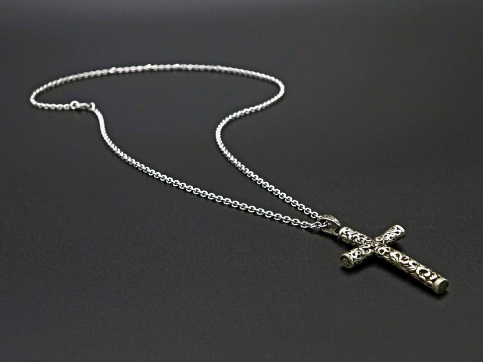 Free Image of Cross Necklace on Black Surface 