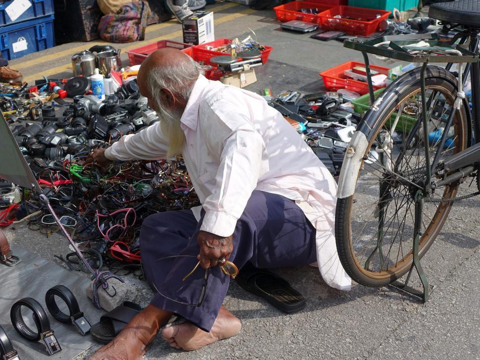 Free Image of Man Working on Bicycle With Wires 
