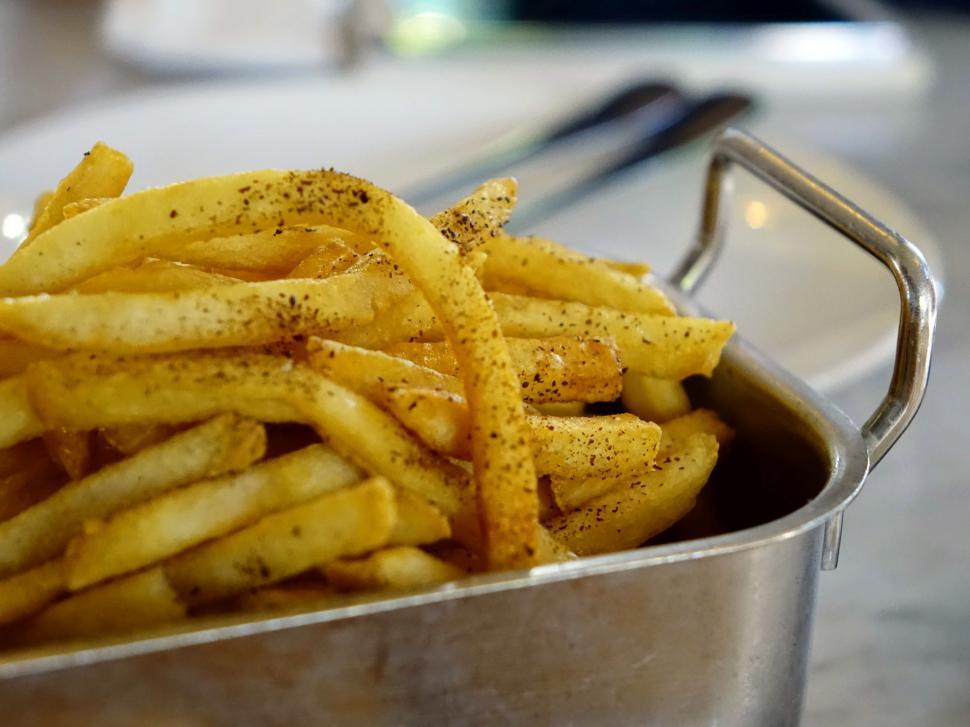 Free Image of Metal Container Filled With French Fries on Table 