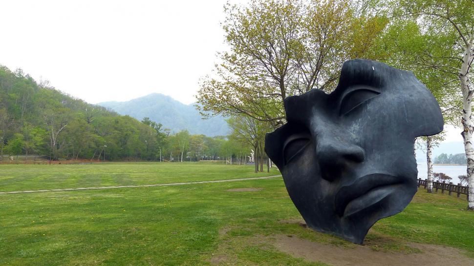 Free Image of Sculpture of a Face in a Park 