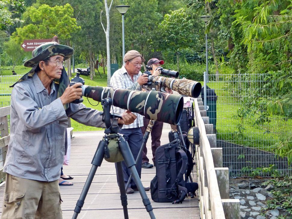 Free Image of Group of People Standing on Bridge With Cameras 