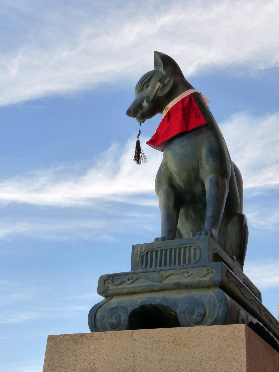 Free Image of Statue of a Dog on Top of a Building 