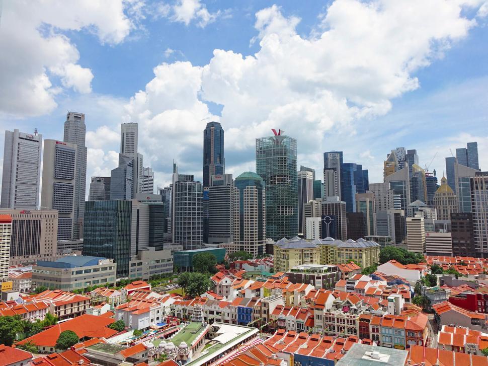 Free Image of Red rooftops and distant skyscrapers, Singapore 