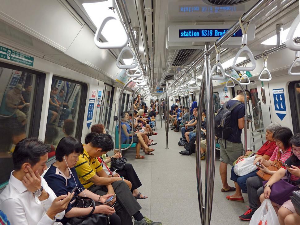 Free Image of Group of People Sitting on Subway Train 