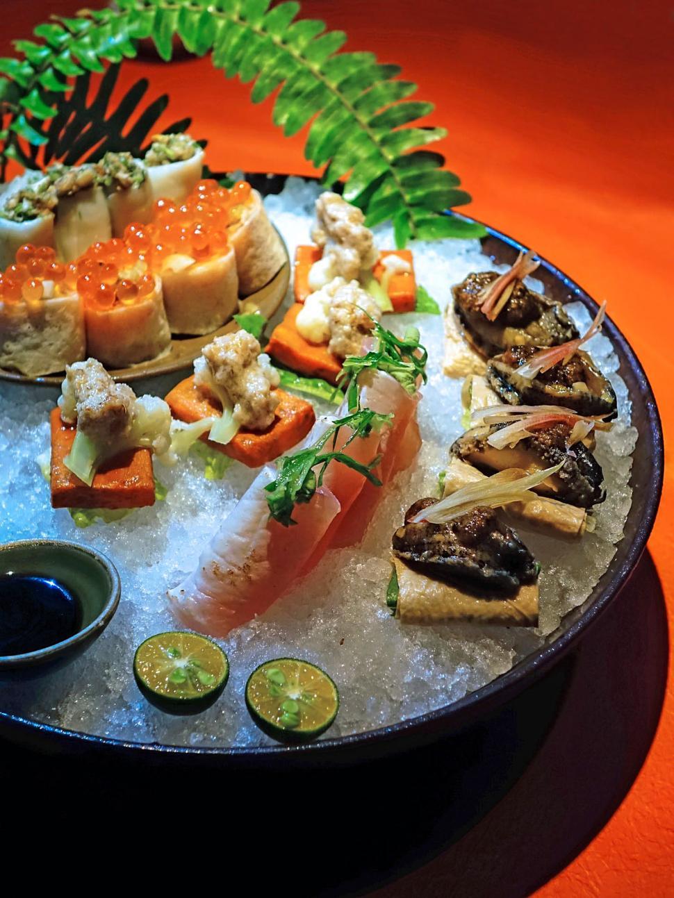 Free Image of A Platter of Sushi and Various Food on a Table 