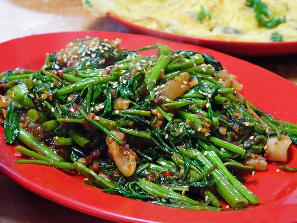 Free Image of Red Plate With Green Vegetables Beside Another Plate of Food 