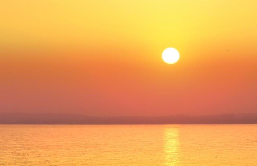 Free Image of Hazy Sunset Over a Calm Sea - Summer Holidays 