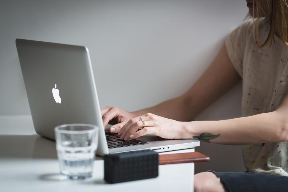 Free Image of Young Woman Typing Macbook 