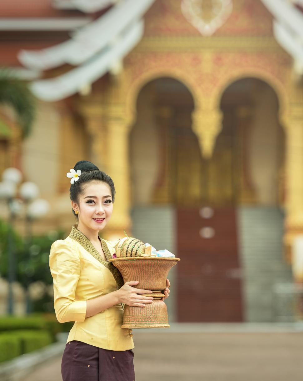 Free Image of Woman Holding Basket in Front of Building 