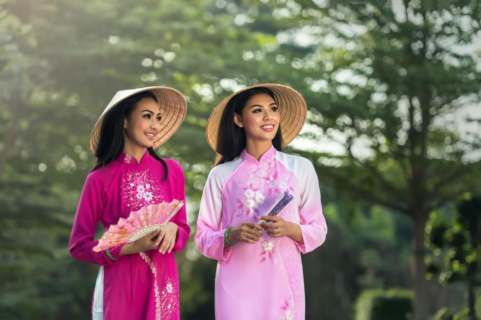 Free Image of Two Women in Pink Outfits Standing Together 