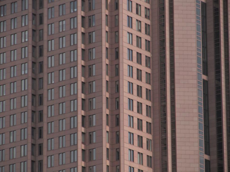 Free Image of Tall Building With Many Windows Among Urban Structures 