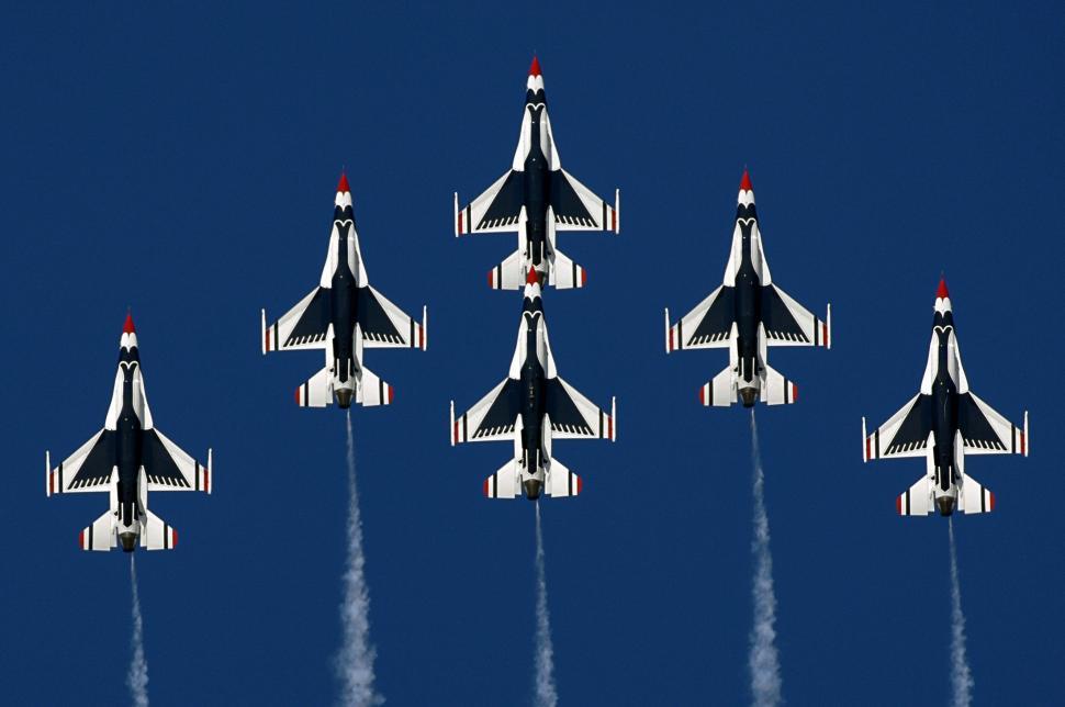 Free Image of Group of Fighter Jets Flying Through a Blue Sky 