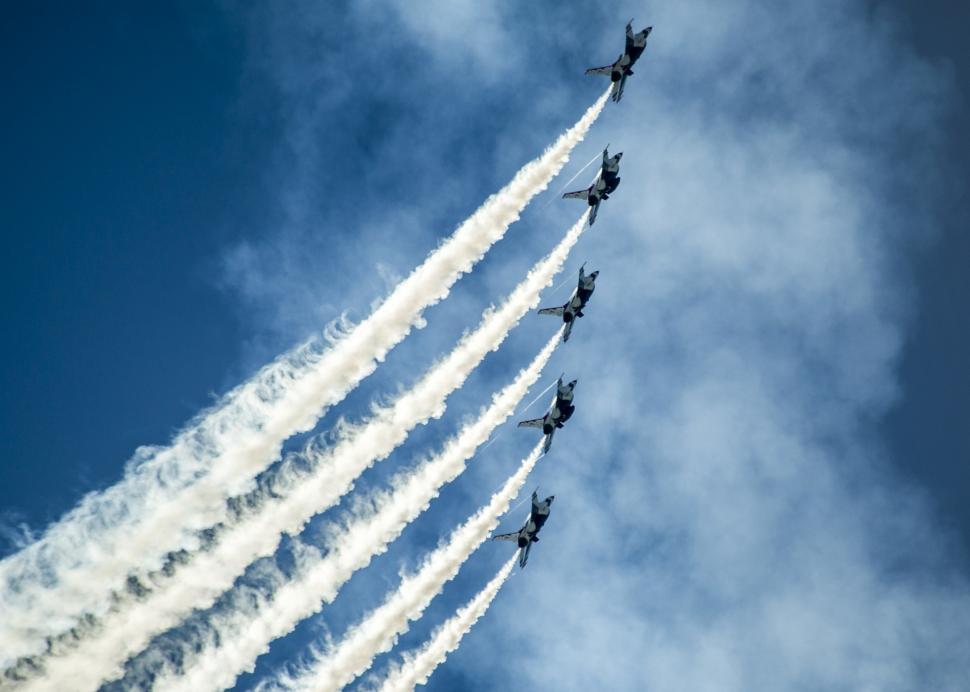 Free Image of Group of Jets Flying Through Cloudy Blue Sky 