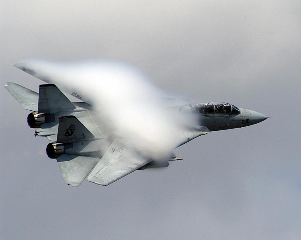 Free Image of Fighter Jet Flying Through Cloudy Sky 