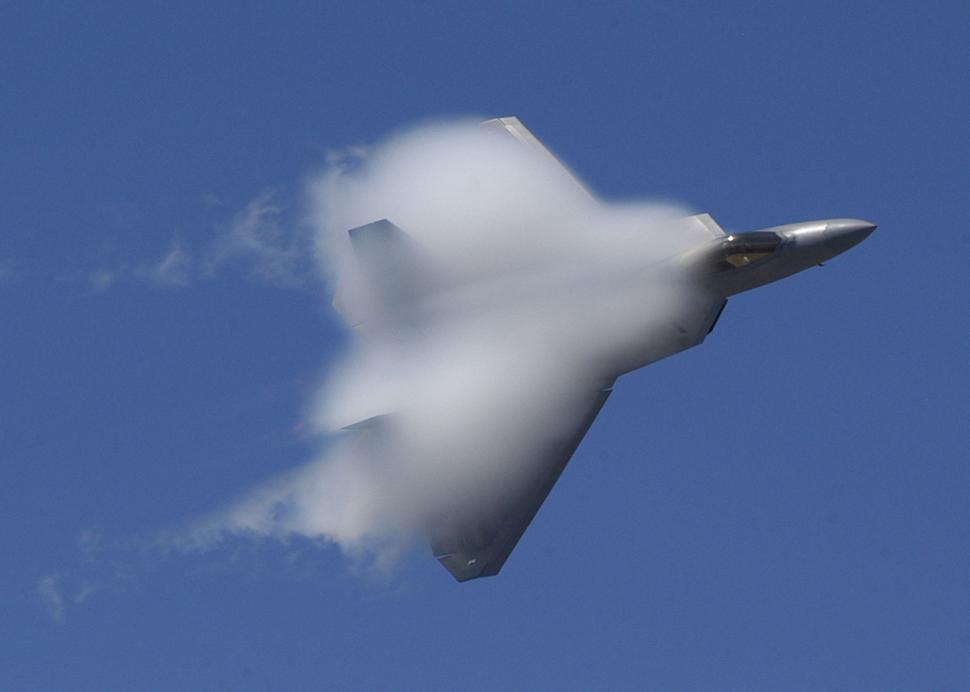 Free Image of Jet Flying Through Blue Sky With White Smoke 