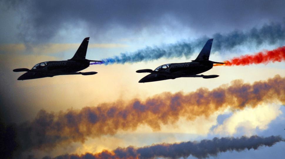 Free Image of Two Airplanes Flying in Formation With Colored Smoke 