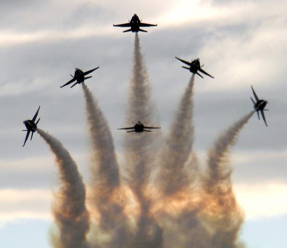 Free Image of A Group of Jets Flying Through a Cloudy Sky 