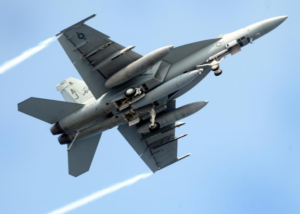 Free Image of Fighter Jet Soaring Through Blue Sky 