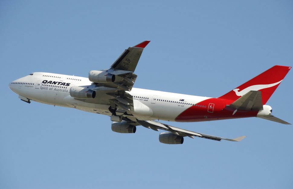 Free Image of Large Passenger Jet Flying Through a Blue Sky 