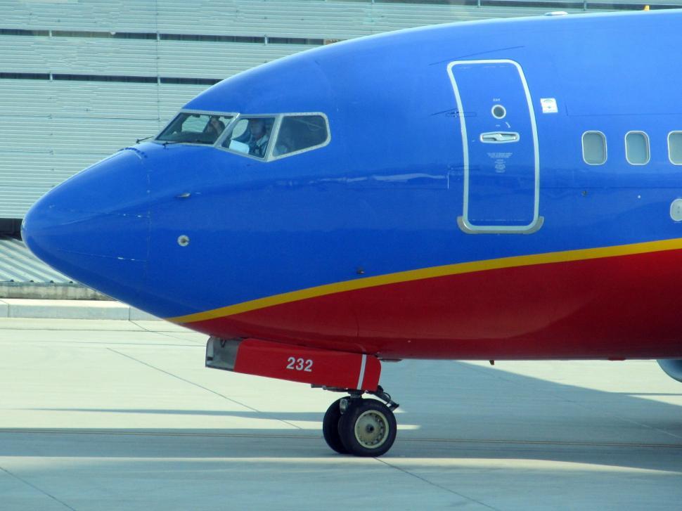 Free Image of Large Blue and Red Airplane on Runway 