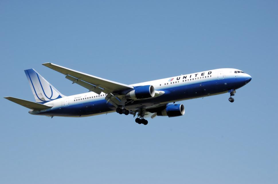 Free Image of Large Jetliner Flying Through Blue Sky 