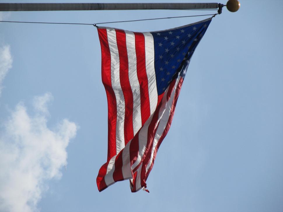 Free Image of American Flag Hanging From Power Line 