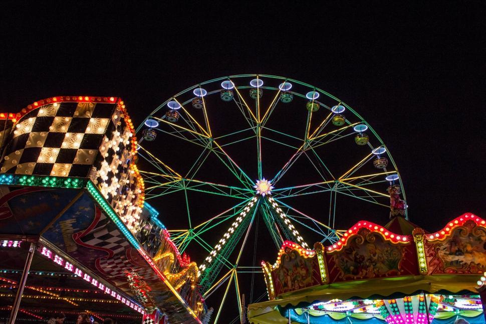 Free Image of Busy Carnival With Ferris Wheel and Checkered Flag 