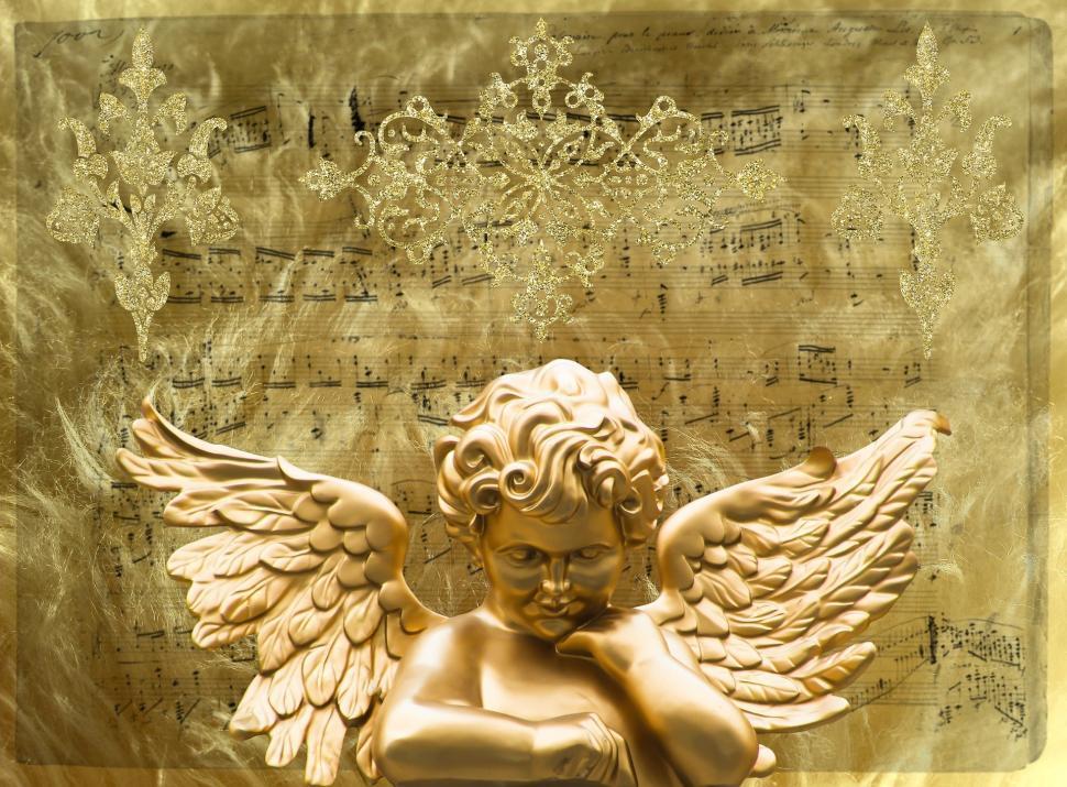 Free Image of Angel Statue Sitting on Sheet of Music 