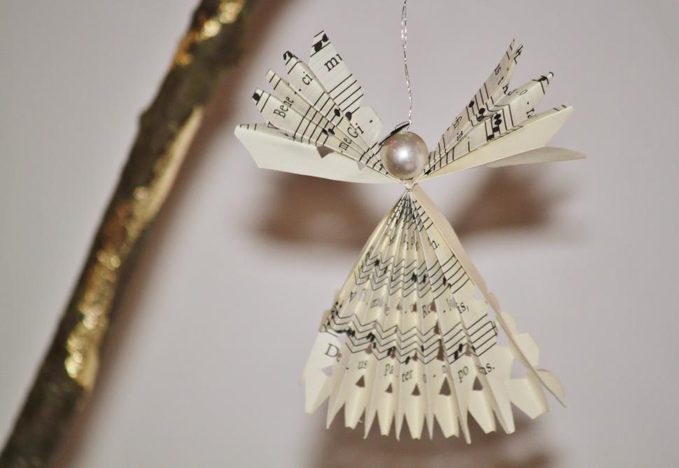 Free Image of Paper Angel Ornament Hanging From Twig 