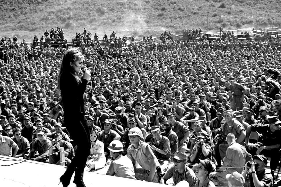 Free Image of Woman Standing in Front of Large Crowd 
