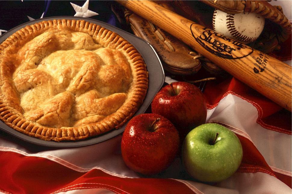 Free Image of Pie and Apples on a Table With Baseball Bats 