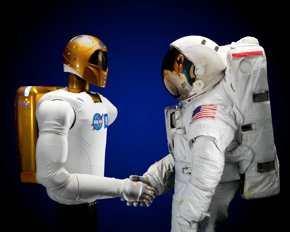 Free Image of Two Astronauts Shaking Hands in Front of a Blue Background 