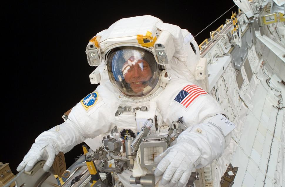 Free Image of Man in Space Suit Standing Next to Wall 