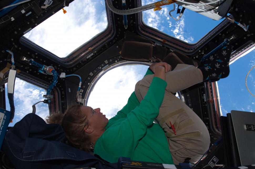 Free Image of Man in Space Station Looking Up Into Sky 