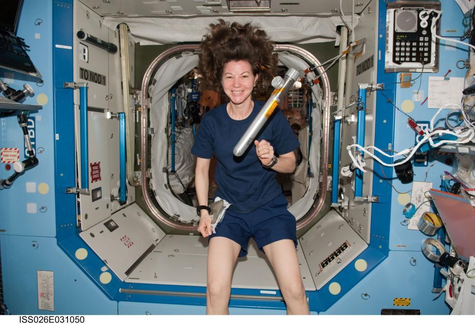 Free Image of Woman in Space Suit Holding Large Object 