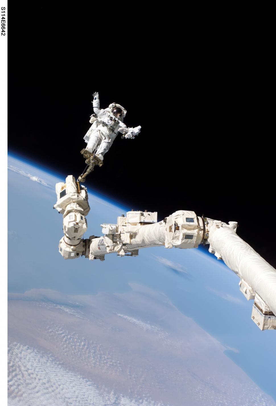 Free Image of Astronaut Floating Next to Space Station 