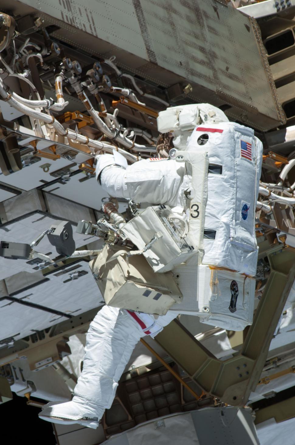 Free Image of Astronaut in White Spacesuit Standing on Metal Structure 