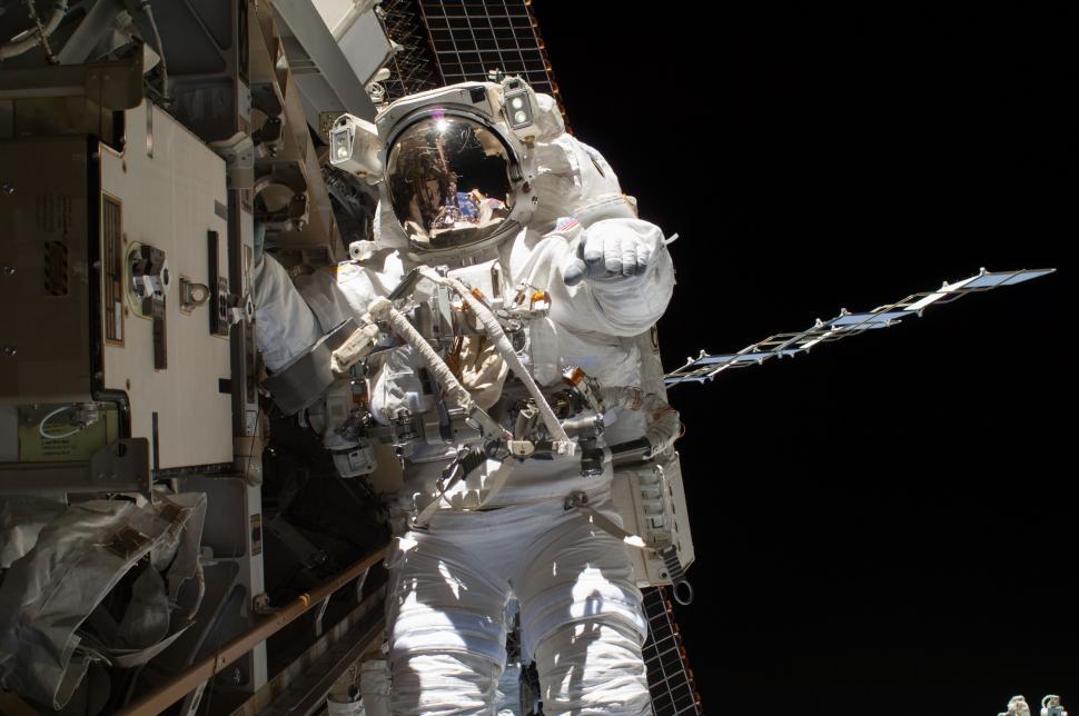 Free Image of Astronaut Standing Next to Fence in Space Suit 