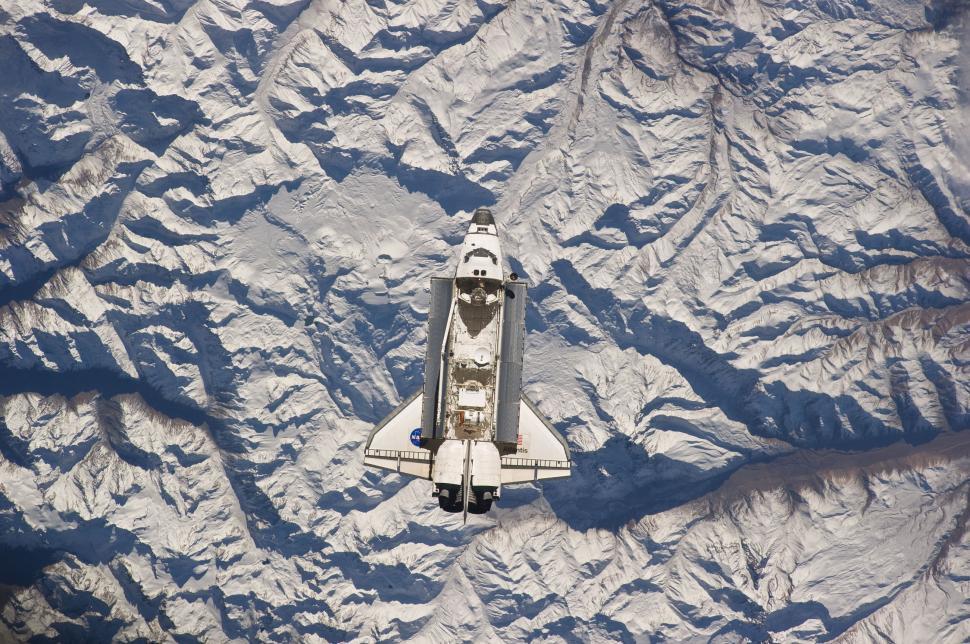 Free Image of Space Shuttle Flying Over Mountain Range 