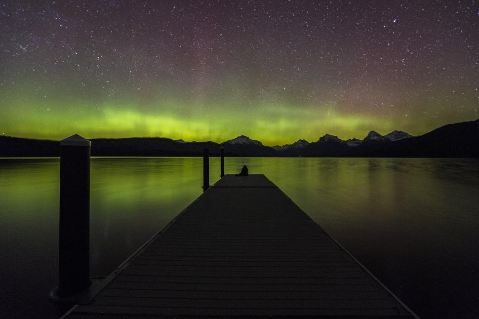 Free Image of Long Dock With Green Light in Sky 