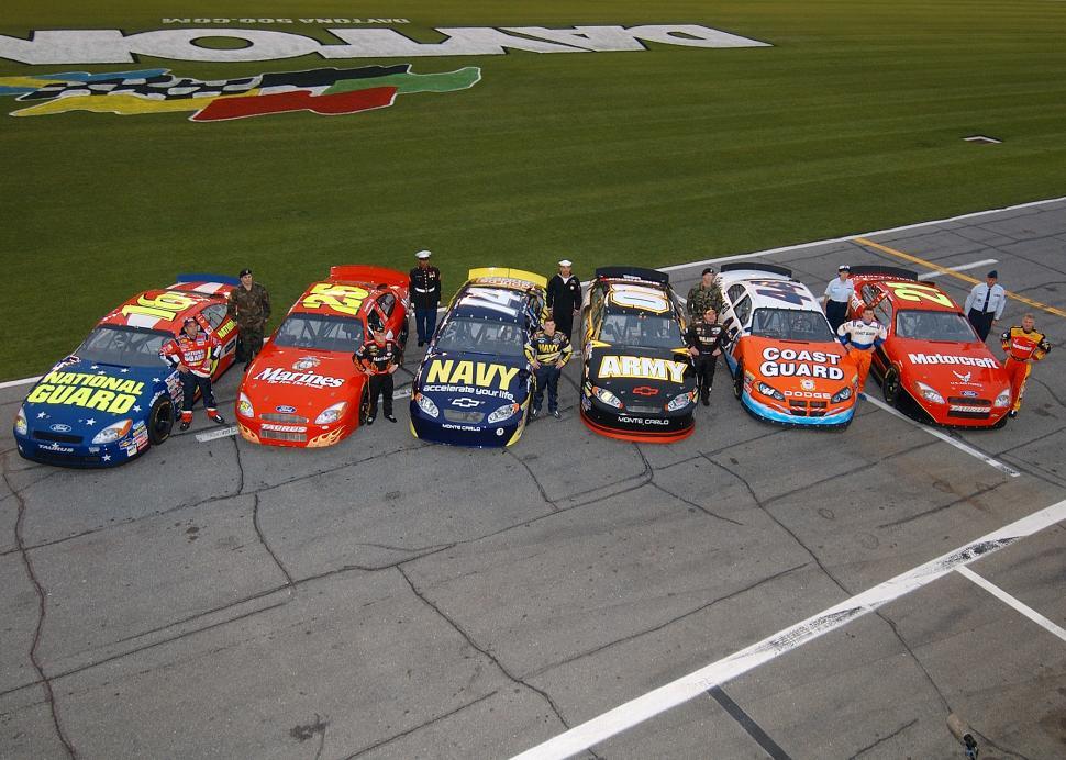 Free Image of Group of Cars Lined Up on a Race Track 