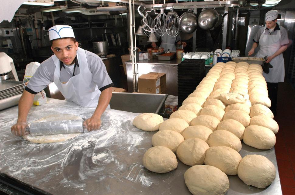 Free Image of Man Making Bread Rolls in Kitchen 