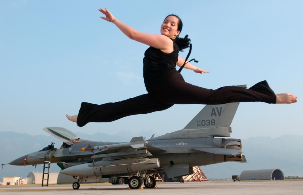Free Image of Woman Jumping in Front of Fighter Jet 
