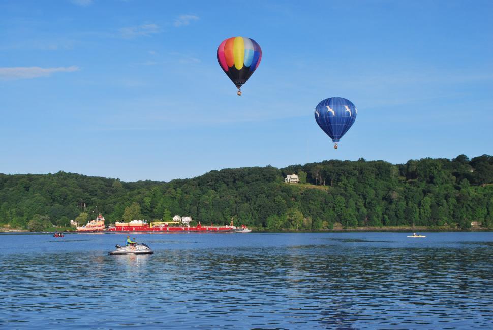 Free Image of Hot Air Balloons Flying Over Lake 
