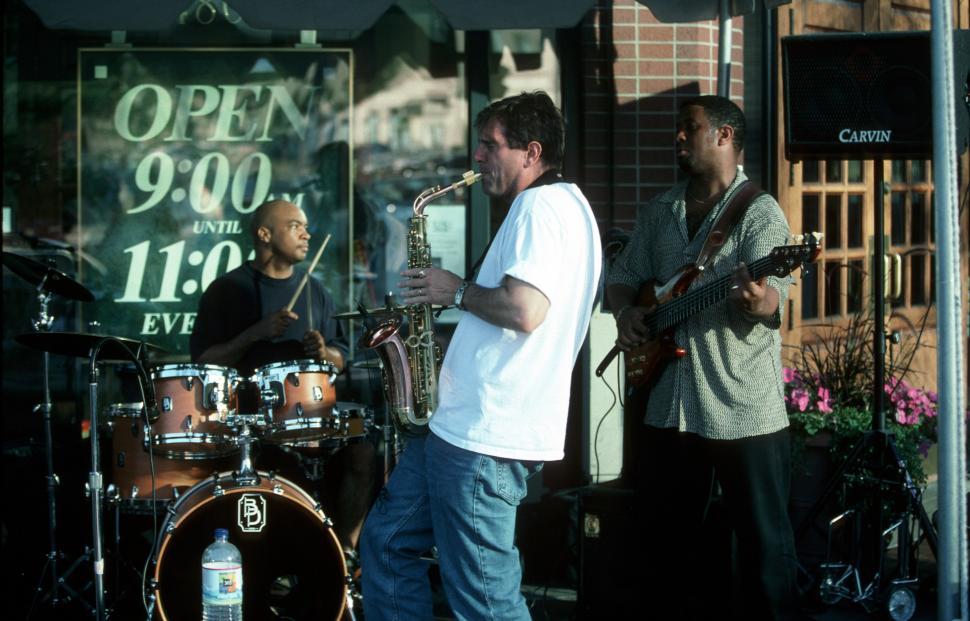Free Image of Group of Men Playing Instruments on a Street 