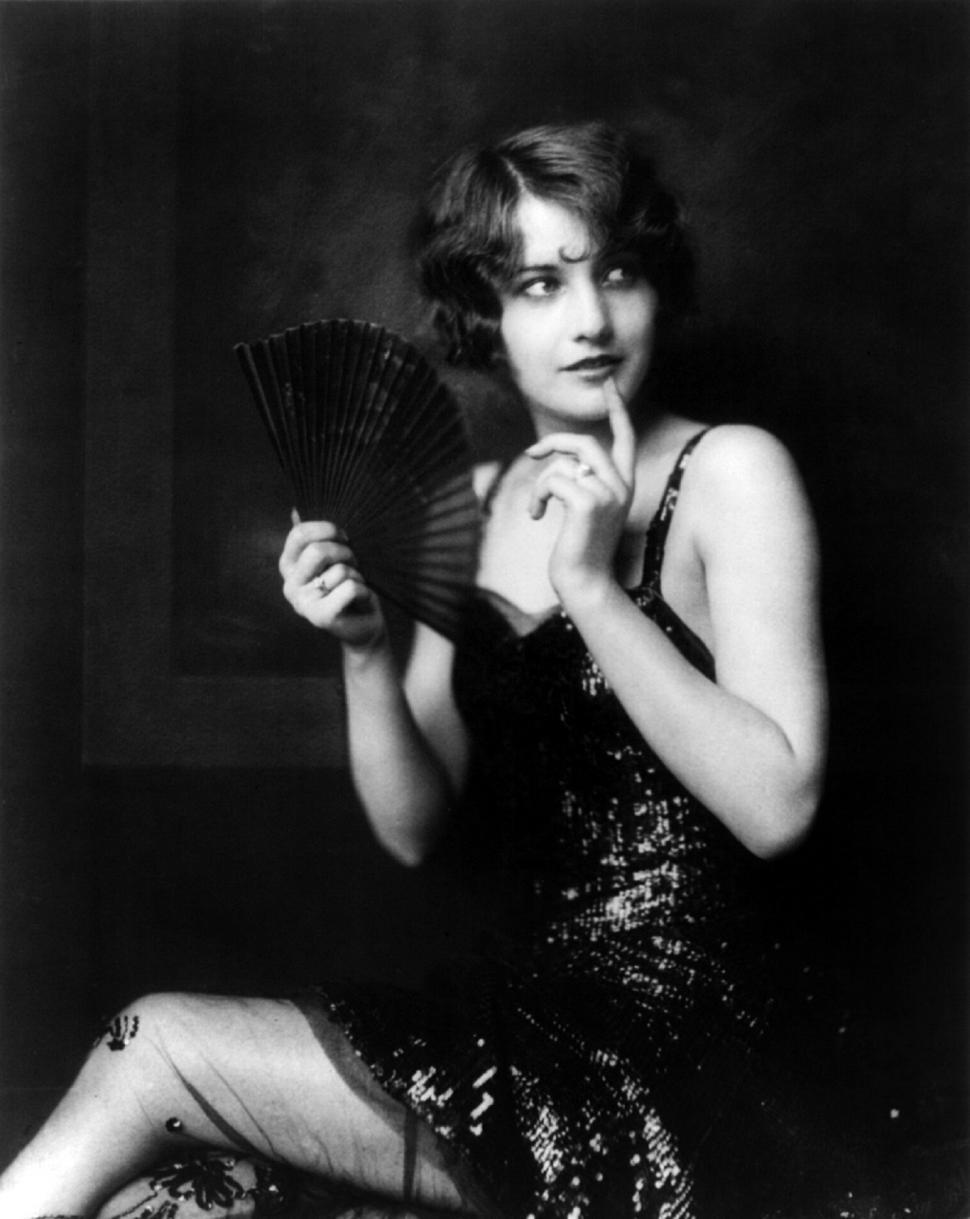 Free Image of Woman Holding Black and White Fan 
