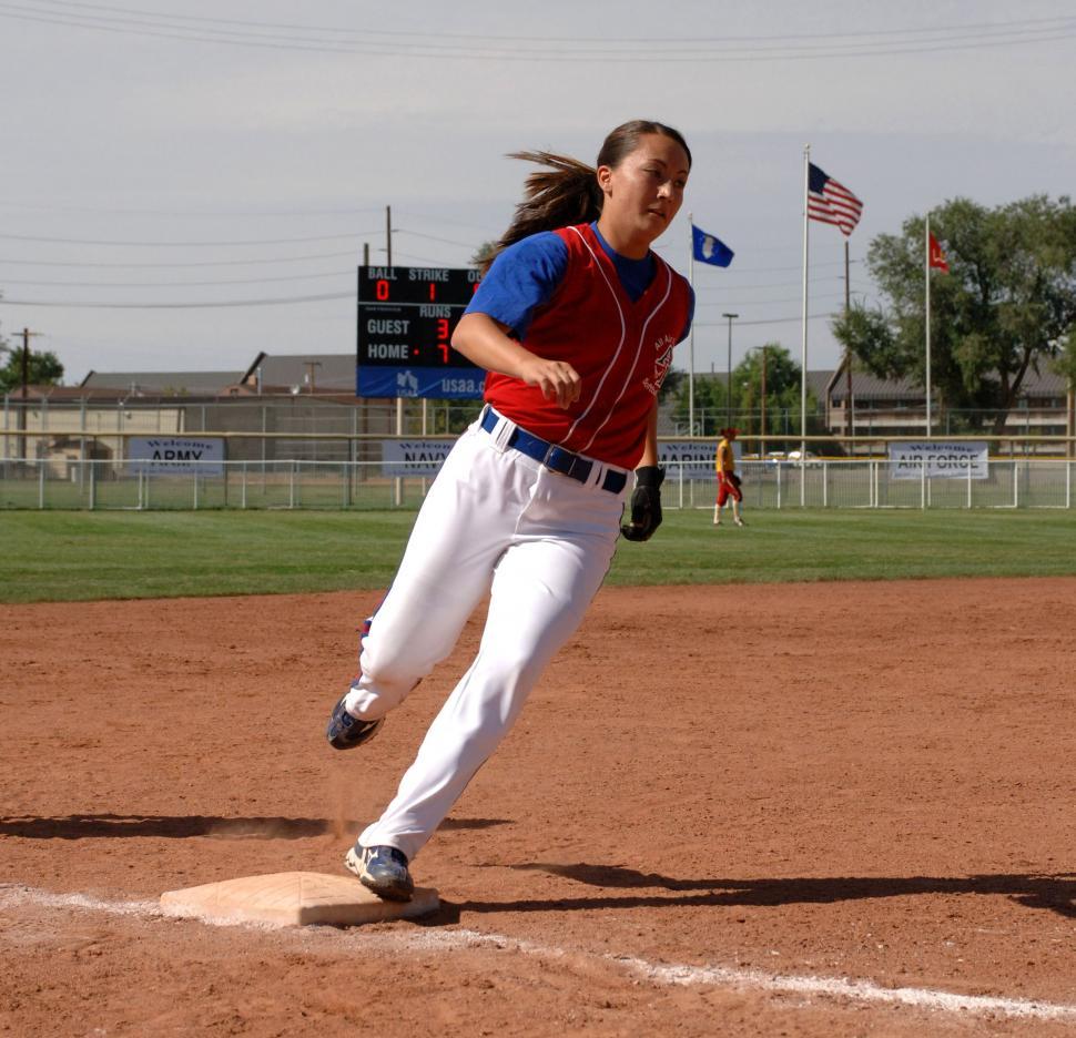 Free Image of Woman Running to First Base in a Baseball Game 