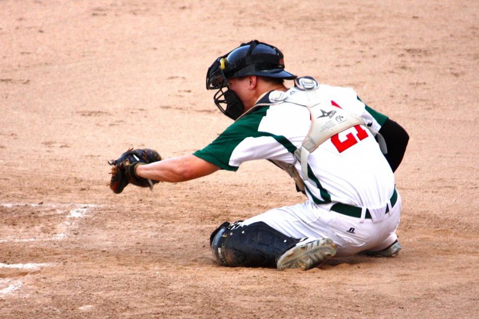 Free Image of Baseball Player Kneeling to Catch Ball 