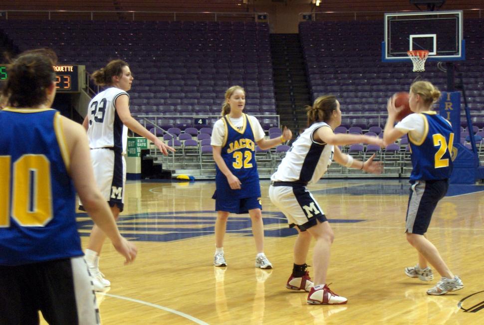 Free Image of Group of Young Women Playing a Game of Basketball 