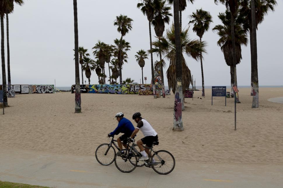Free Image of Couple Riding Bikes on Beach 